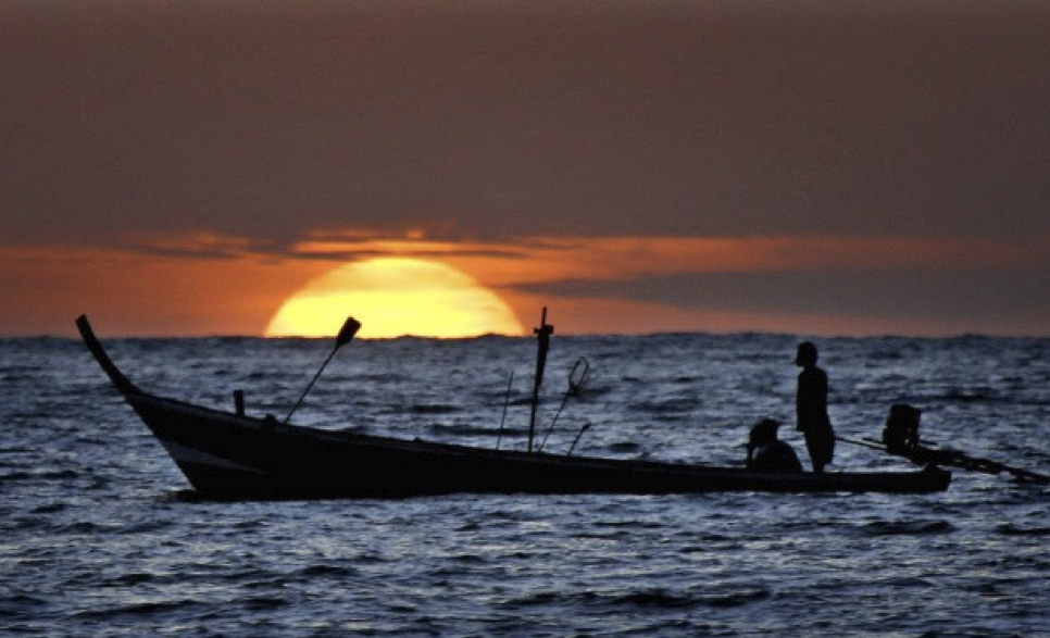 A fishing boat making its way back to the port off Patong Beach, Thailand. Photo Credit: AP Images